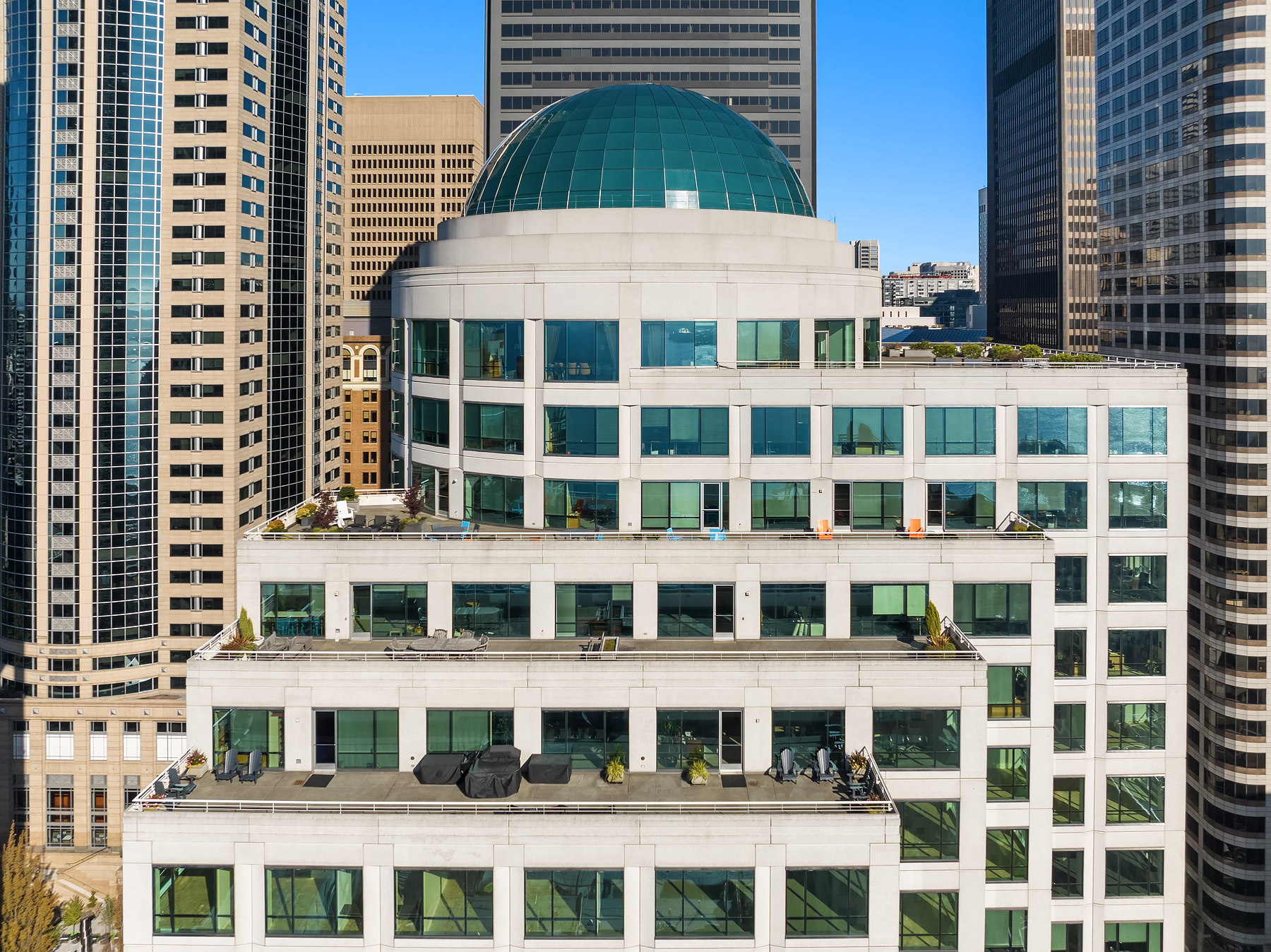 Second and Seneca’s green glass dome and terraced upper floors among downtown Seattle towers