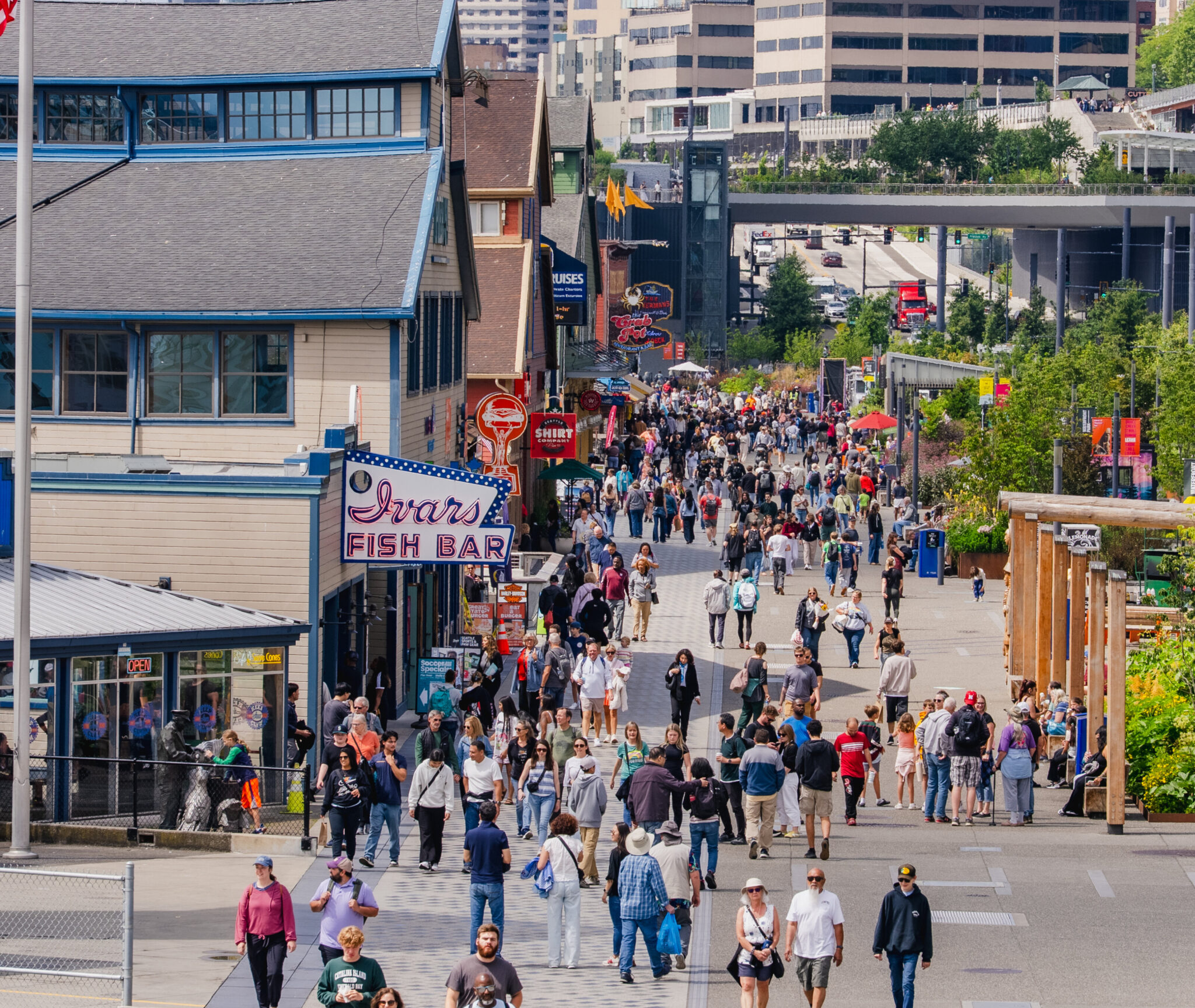 Crowds walking the Seattle waterfront past Ivar’s Fish Bar